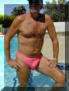The L'Amant, semi-sheer men's thong swimsuit. Shown here is Coral